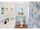 Bright bathroom featuring a window, toilet, vanity with sink, and decorative shower curtain at 1805 Lawrence Rd, Hillsborough, NC 27278