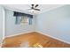 Clean and bright bedroom with hardwood floors and a large window at 1805 Lawrence Rd, Hillsborough, NC 27278