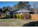 Charming home with manicured lawn, mature shrubs and a screened-in porch at 1805 Lawrence Rd, Hillsborough, NC 27278