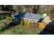 Aerial view of brick home with manicured lawn and mature landscaping in a neighborhood at 1805 Lawrence Rd, Hillsborough, NC 27278