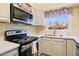 Updated kitchen with stainless steel appliances and a bright window over the sink at 1805 Lawrence Rd, Hillsborough, NC 27278