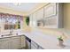 The kitchen has ample counter space, clean white cabinets, and bright, cheerful decor at 1805 Lawrence Rd, Hillsborough, NC 27278