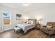 Cozy bedroom with wood floors, large window and comfortable armchair at 190 Salem Village Dr, Fuquay Varina, NC 27526