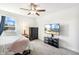 This bedroom features neutral tones, a ceiling fan, and a television, creating a relaxing and inviting space at 190 Salem Village Dr, Fuquay Varina, NC 27526