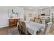Bright dining room featuring modern art, wood flooring, and an open floor plan leading to the kitchen at 190 Salem Village Dr, Fuquay Varina, NC 27526