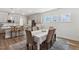 Elegant dining room with gray cabinets, modern lighting, and laminate wood flooring at 190 Salem Village Dr, Fuquay Varina, NC 27526