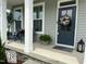 Charming front porch with gray siding, blue door with wreath, and inviting seating at 190 Salem Village Dr, Fuquay Varina, NC 27526