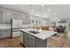 Open kitchen with island, stainless steel appliances, and view to dining and living areas at 190 Salem Village Dr, Fuquay Varina, NC 27526