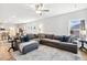 Spacious living room with plush seating, large windows, and seamless transition to the modern kitchen at 190 Salem Village Dr, Fuquay Varina, NC 27526