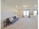Spacious loft area featuring plush carpet, contemporary decor, and ample natural light from large windows at 190 Salem Village Dr, Fuquay Varina, NC 27526