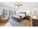 Inviting primary bedroom featuring a king-size bed, neutral tones, and windows for ample natural light at 190 Salem Village Dr, Fuquay Varina, NC 27526