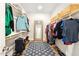 Organized walk-in closet with clothing racks, shelves, mirror and a stylish blue rug at 190 Salem Village Dr, Fuquay Varina, NC 27526