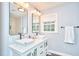Contemporary bathroom featuring dual vessel sinks, updated lighting, and modern finishes at 1921 Clark Ave # 105, Raleigh, NC 27605