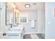 Modern bathroom with dual sinks, sleek fixtures, and tiled walk-in shower at 1921 Clark Ave # 105, Raleigh, NC 27605