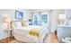 Cozy bedroom with a comfortable bed, bright natural light, and hardwood floors at 1921 Clark Ave # 105, Raleigh, NC 27605