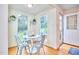 Bright breakfast nook with white tulip table, steel chairs, and beautiful outdoor views at 1921 Clark Ave # 105, Raleigh, NC 27605