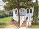 Charming front entrance with brick stairs, white railings, and a well-kept lawn at 1921 Clark Ave # 105, Raleigh, NC 27605