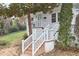 Charming front entrance with brick stairs, white railings, and a well-kept lawn at 1921 Clark Ave # 105, Raleigh, NC 27605