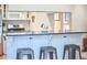 Stylish kitchen island featuring sleek barstools and a view into the living room at 1921 Clark Ave # 105, Raleigh, NC 27605