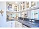 Kitchen boasts granite countertops, glass-front cabinets, and an open view to the living area at 1921 Clark Ave # 105, Raleigh, NC 27605
