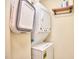 A compact laundry area featuring a stacked washer and dryer unit at 1921 Clark Ave # 105, Raleigh, NC 27605