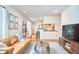 Comfortable living room featuring a modern leather couch and an open floor plan at 1921 Clark Ave # 105, Raleigh, NC 27605