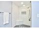 Modern shower with white subway tile, black fixtures, and a built-in seat at 1921 Clark Ave # 105, Raleigh, NC 27605