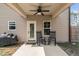 Covered back porch with two rocking chairs overlooking the backyard and grill at 20 W Park Ln, Sanford, NC 27332