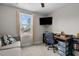 Bedroom area featuring a desk, comfortable chair, and a mounted TV at 20 W Park Ln, Sanford, NC 27332