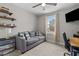 Comfortable bedroom with a cozy sofa, floating shelves, and ample natural light at 20 W Park Ln, Sanford, NC 27332
