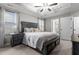 Inviting main bedroom with a wooden bed frame, tray ceiling, and ample natural light at 20 W Park Ln, Sanford, NC 27332