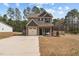 Charming two-story home with a one-car garage, manicured lawn, and inviting front porch at 20 W Park Ln, Sanford, NC 27332