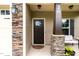 Inviting front porch with stacked stone accents, a dark front door, and space for seating at 20 W Park Ln, Sanford, NC 27332