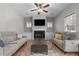 Cozy living room with a fireplace, a ceiling fan, and recessed lighting at 20 W Park Ln, Sanford, NC 27332