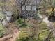 Aerial shot of gray home surrounded by mature trees, beautiful lawn, and a long driveway at 2005 Bridgeport Dr, Raleigh, NC 27615