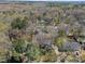 Overhead view of a neighborhood nestled in a forest with a mix of deciduous and evergreen trees at 2005 Bridgeport Dr, Raleigh, NC 27615