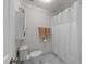 Functional bathroom featuring a toilet, white cabinet, and shower with white tile and curtain at 2005 Bridgeport Dr, Raleigh, NC 27615