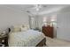 Comfortable bedroom features a patterned bedspread, neutral walls, carpet, and natural light at 2005 Bridgeport Dr, Raleigh, NC 27615