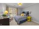 Bright bedroom featuring a bed, desk, large window, and yellow bedside table at 2005 Bridgeport Dr, Raleigh, NC 27615