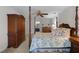 Inviting bedroom featuring a four-poster bed, warm neutral walls, and a glimpse into the bathroom at 2005 Bridgeport Dr, Raleigh, NC 27615