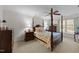 Cozy bedroom with a four-poster bed, ceiling fan, neutral walls, and ample natural light at 2005 Bridgeport Dr, Raleigh, NC 27615