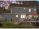 Back of house featuring a deck, patio, and well maintained lawn at 2005 Bridgeport Dr, Raleigh, NC 27615