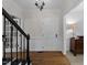 Inviting foyer with hardwood floors, staircase with black iron railing and white trim at 2005 Bridgeport Dr, Raleigh, NC 27615