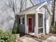 Close-up of a gray house with a bright red front door, trimmed with white railing at 2005 Bridgeport Dr, Raleigh, NC 27615