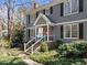 Charming two-story home with gray siding, black shutters, front porch, and landscaped yard at 2005 Bridgeport Dr, Raleigh, NC 27615
