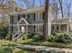 Charming two-story home with gray siding, black shutters, front porch, and landscaped yard at 2005 Bridgeport Dr, Raleigh, NC 27615