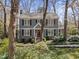 Charming two-story home with gray siding, black shutters, front porch, and landscaped yard at 2005 Bridgeport Dr, Raleigh, NC 27615