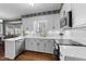 Bright kitchen features white cabinets, stainless steel appliances, and wood flooring at 2005 Bridgeport Dr, Raleigh, NC 27615