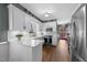 Bright kitchen features white cabinets, stainless steel appliances, and updated countertops at 2005 Bridgeport Dr, Raleigh, NC 27615