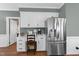 Bright kitchen features white cabinets, stainless steel appliances, and a built in desk at 2005 Bridgeport Dr, Raleigh, NC 27615
